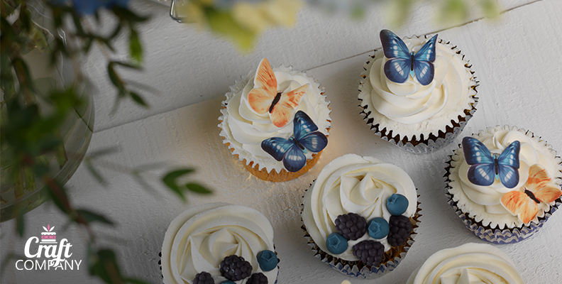 Cupcakes adorned with edible butterfly decorations from Craft Company.