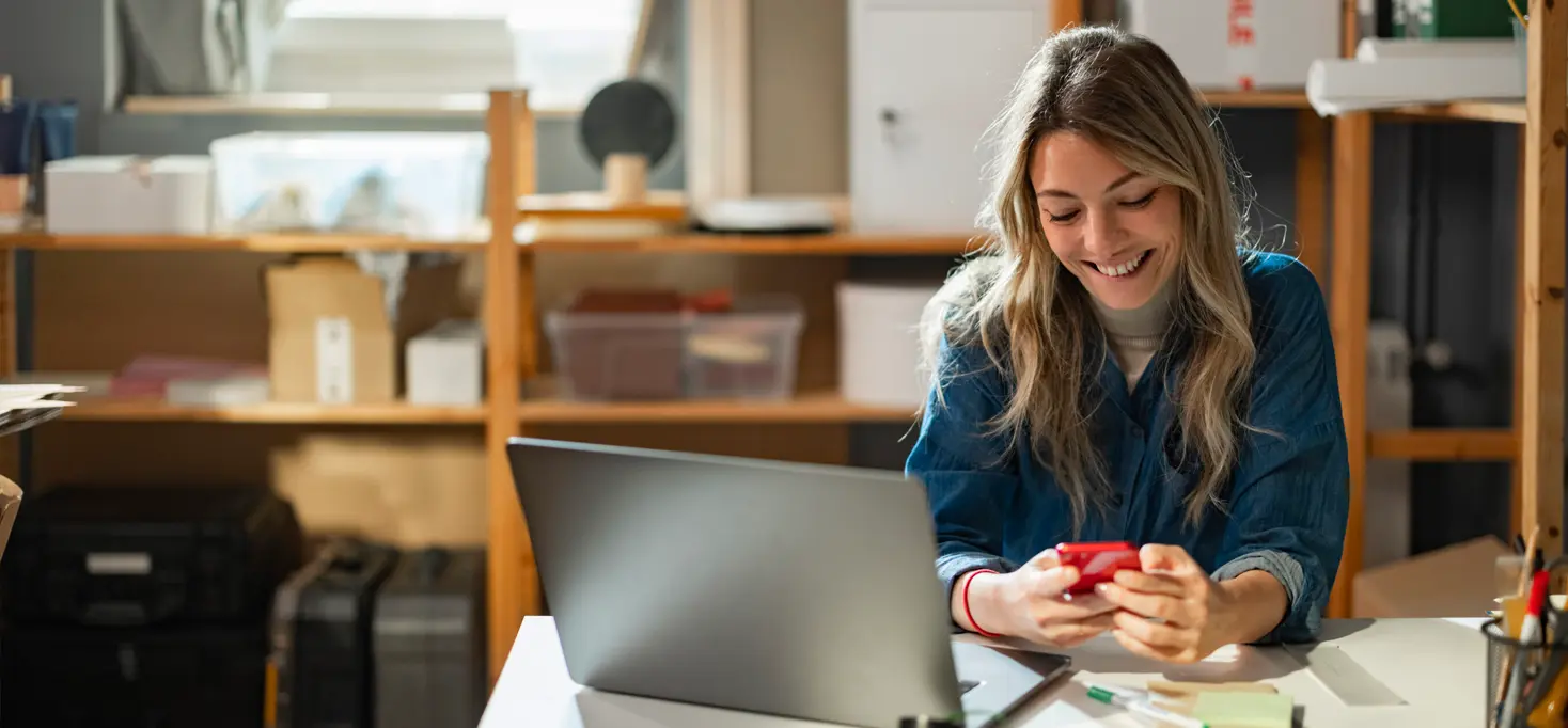 woman holding phone to indicate looking at an ESP migration checklist