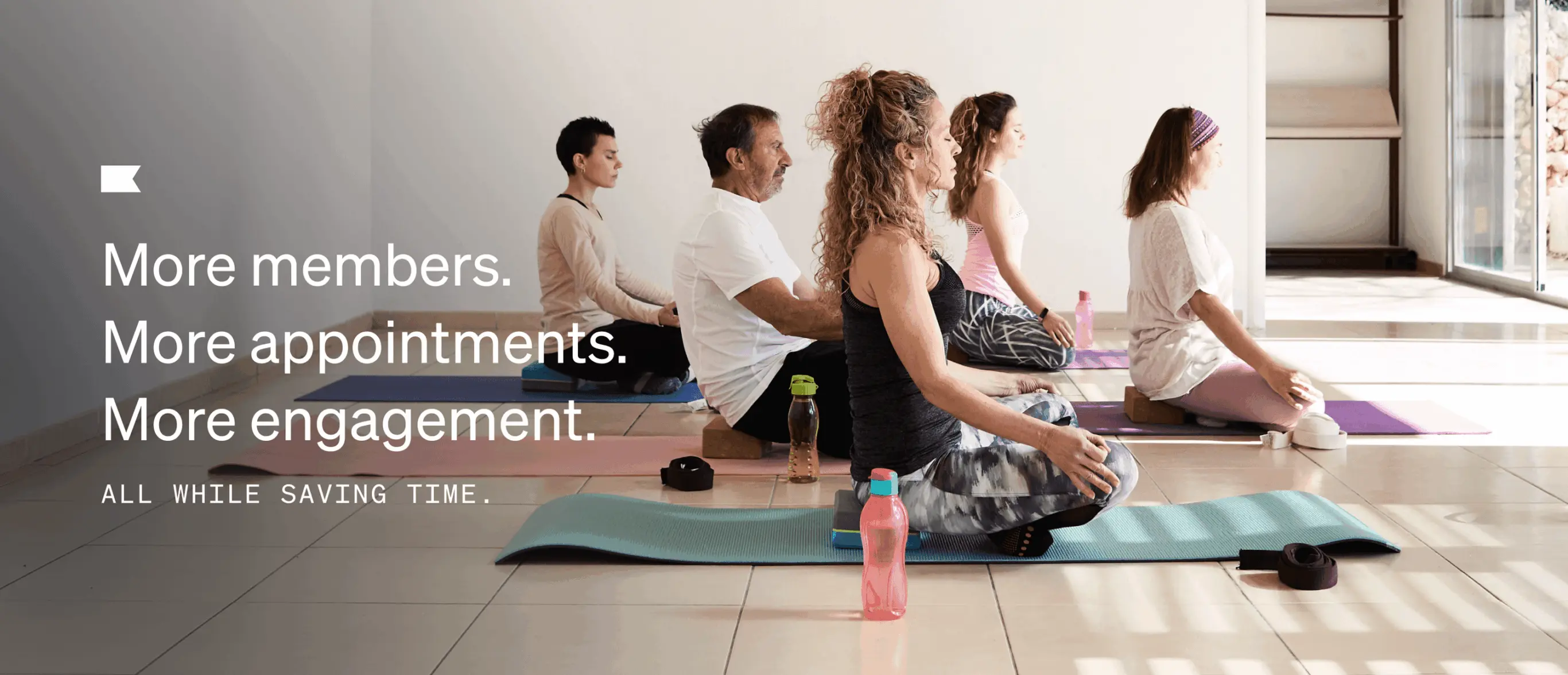 People sitting on yoga mats in a meditation pose indoors. Text: "More members. More appointments. More engagement. All while saving time.