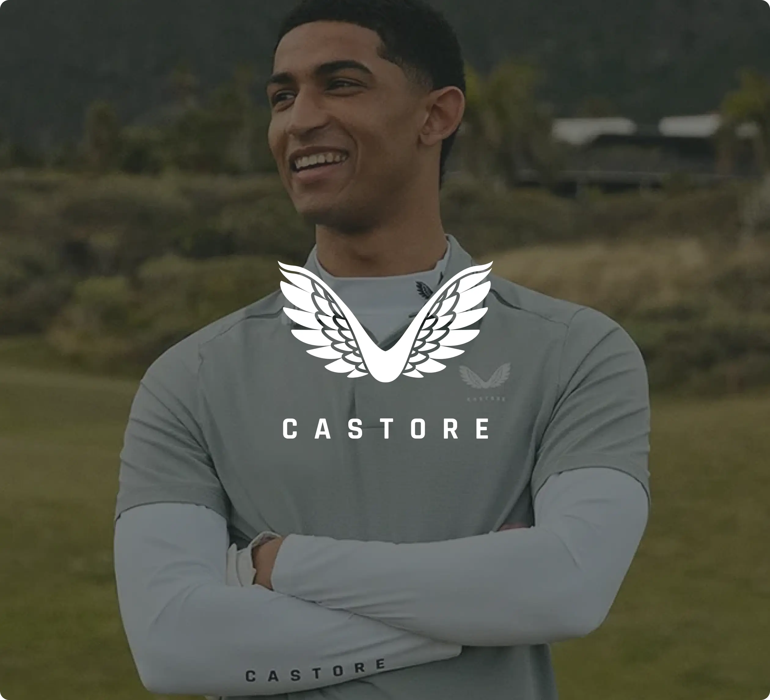 Smiling person wearing a grey Castore sports top with the Castore logo and text overlay.