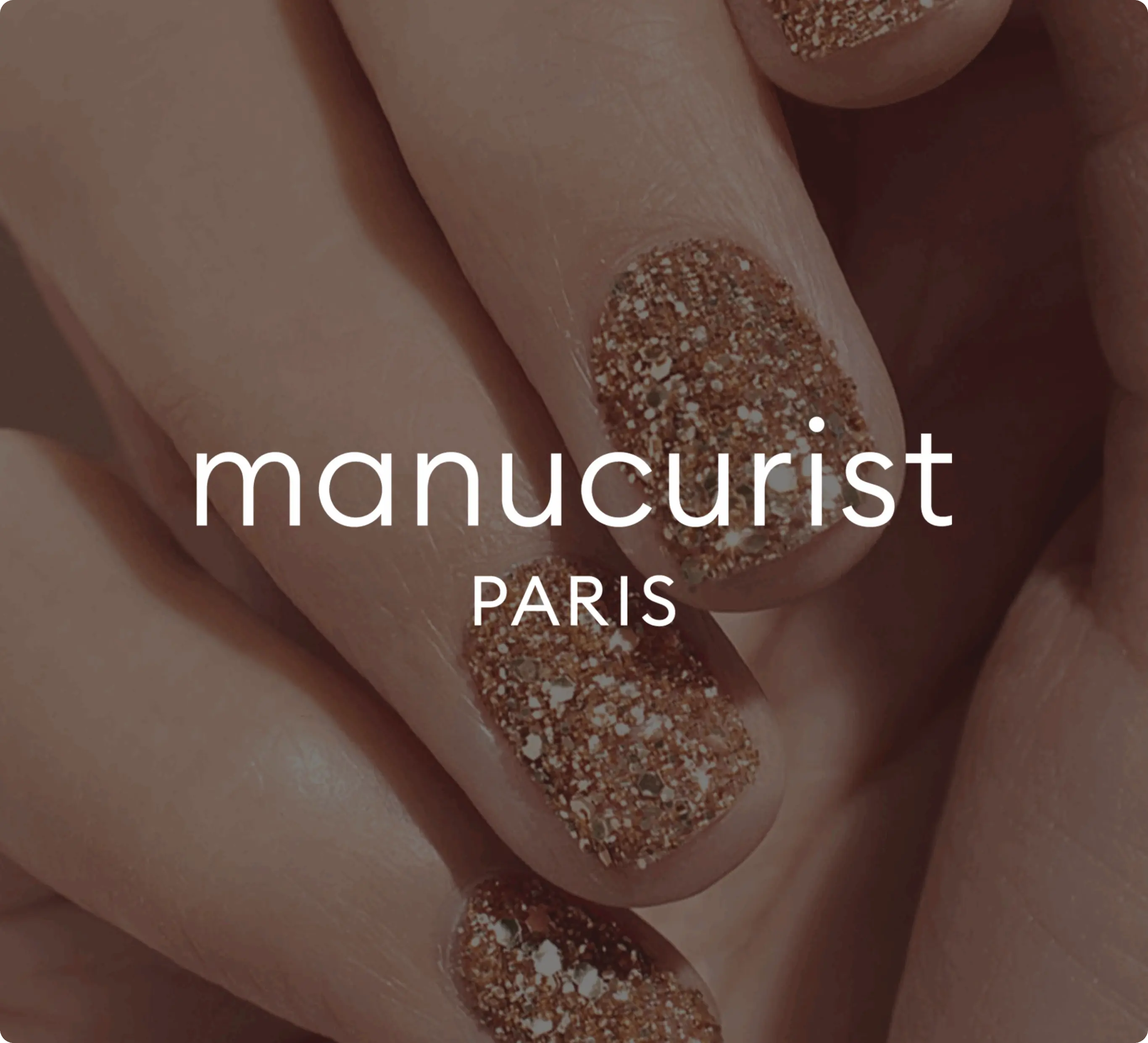 Close-up of hands with glittery gold nail polish, overlaid with the text "manucurist PARIS".