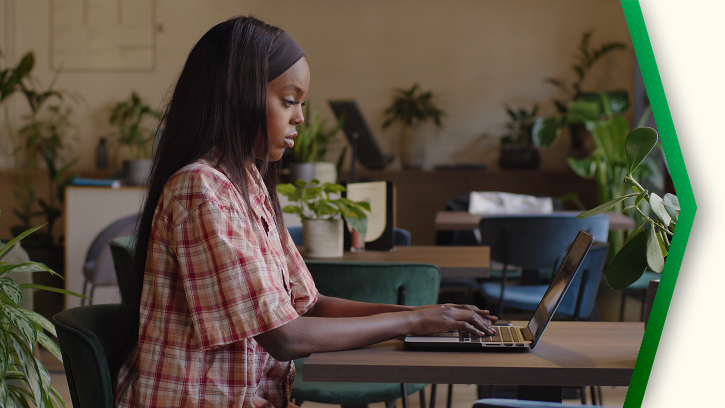 an image of a woman sitting at a laptop typing