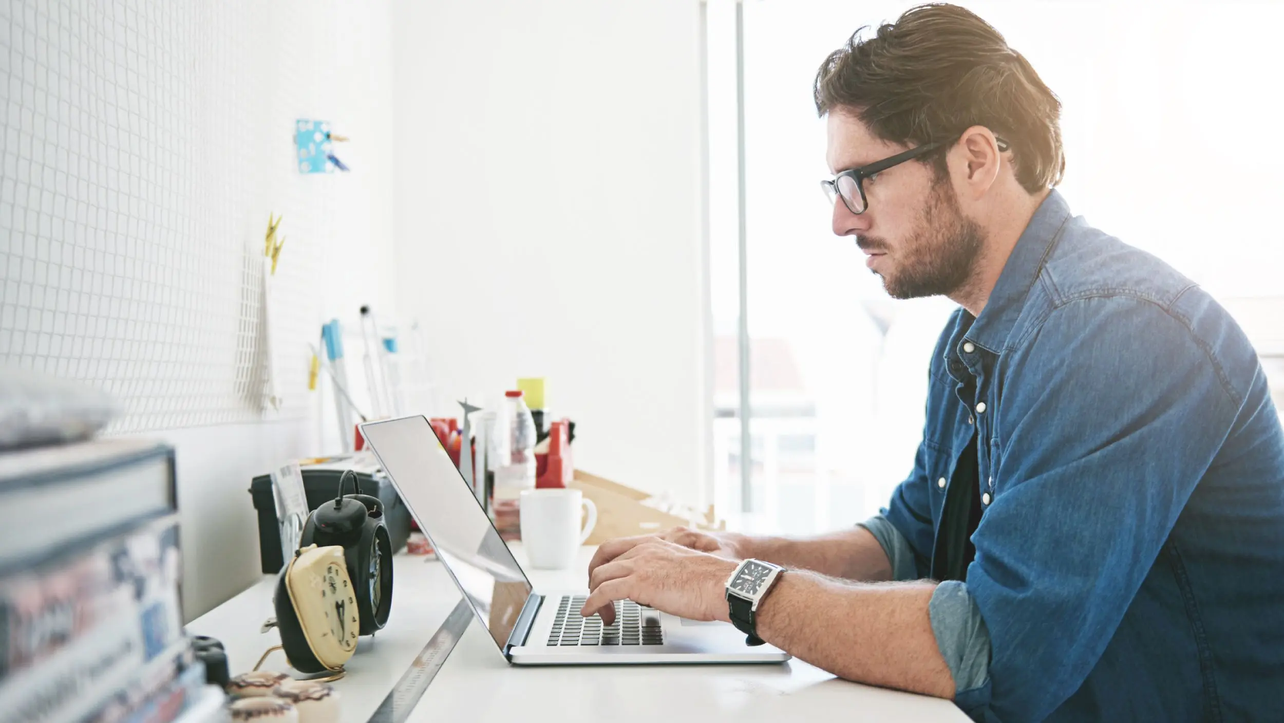 A man sitting at a desk typing on a computer