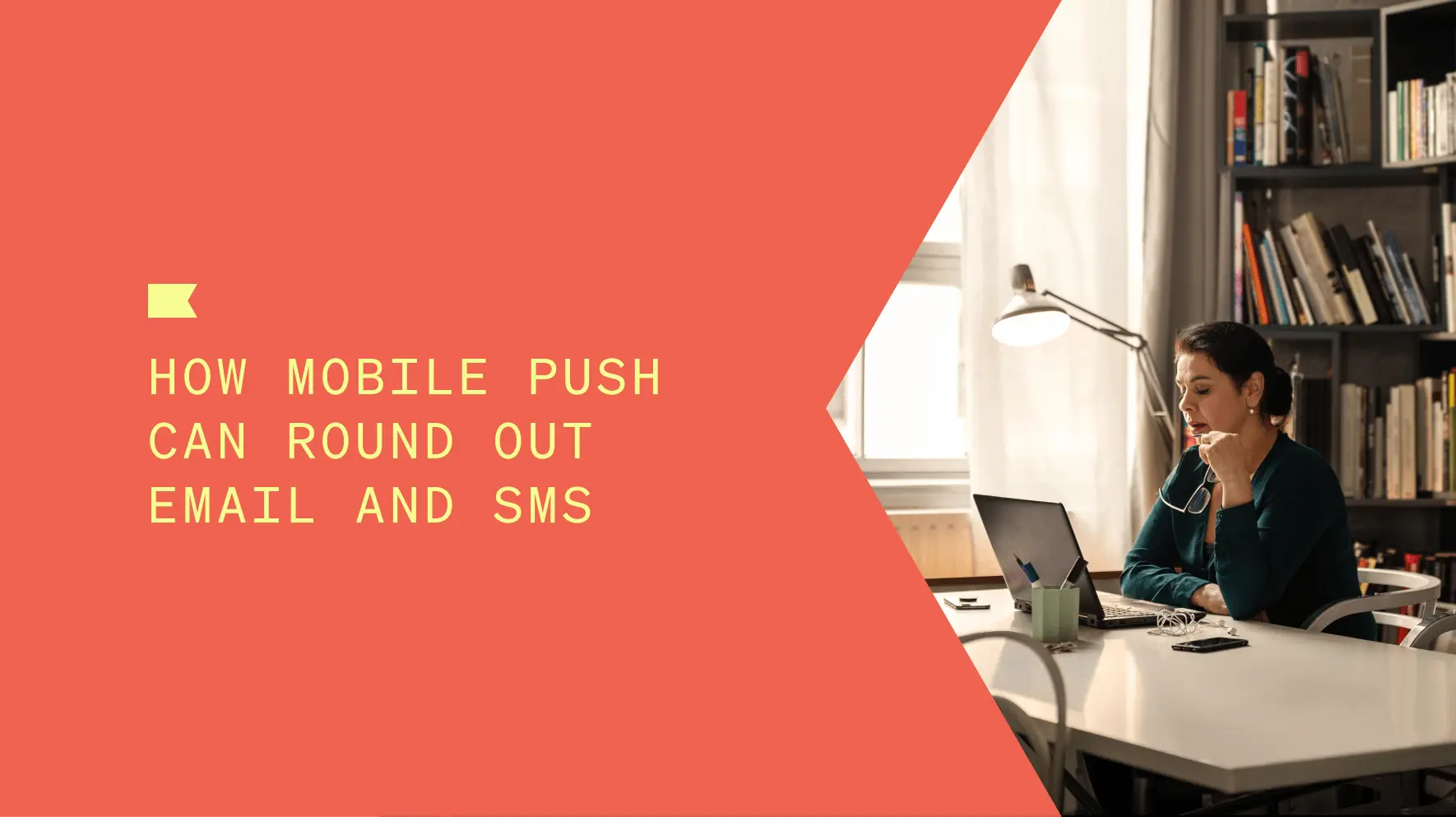 Title of blog: How mobile push can round out email and SMS, with a woman sitting at a table looking at a laptop